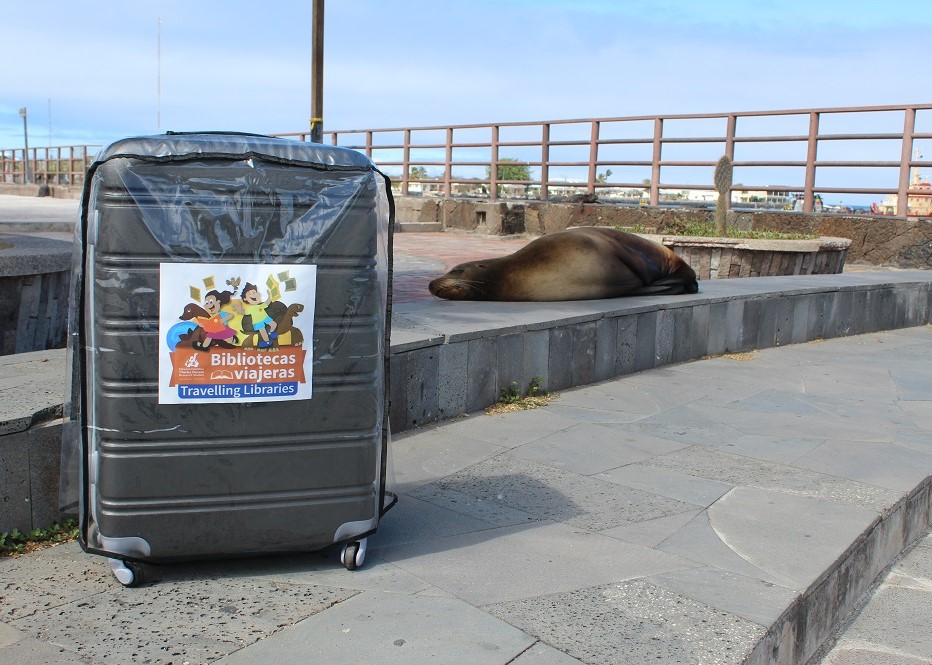 Photo of "Biblioteca Viajera" de la FCD llegando a Puerto Baquerizo Moreno, isla San Cristóbal, con un león marino de fondo